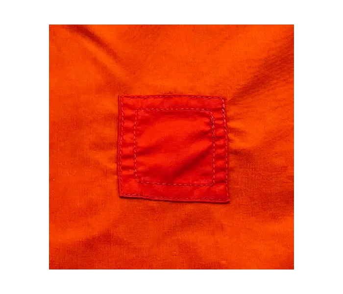 Windshell after repair: with a slightly different covering over the hole than the original fabric.