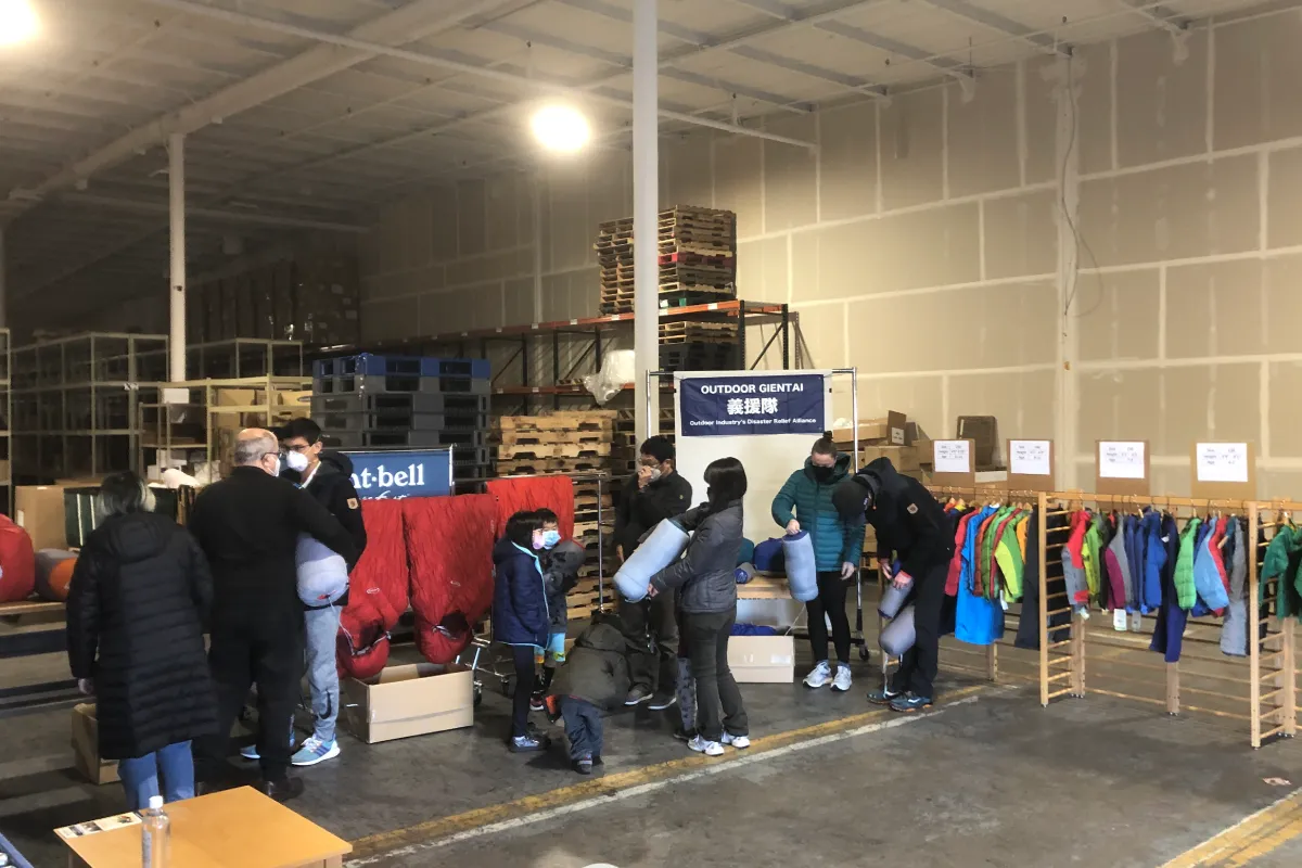 A warehouse storing relief supplies. Disaster victims are receiving supplies.