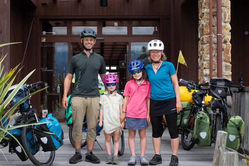 The Pasch family standing with their bicycles in front of the Montbell store