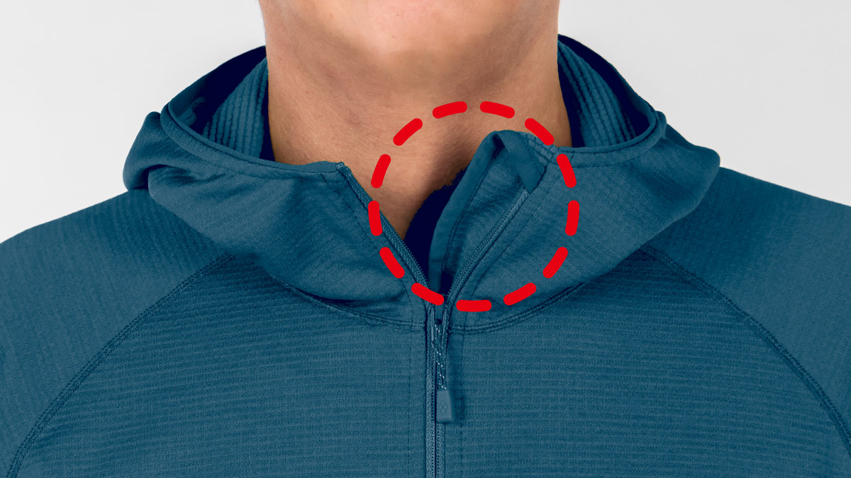 Close-up photograph of the CLIMAGRID Hooded Jacket 's collar area. The focus is on the flap of the front zipper.