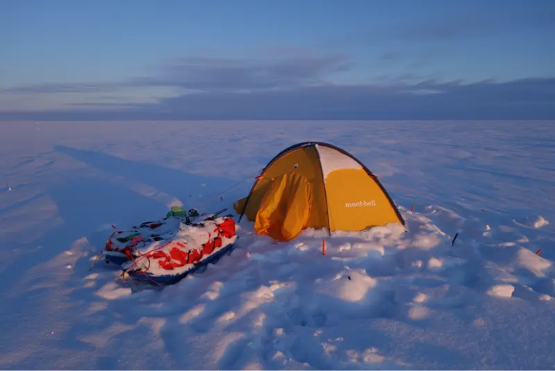 A tent on the ice and a sled next to it