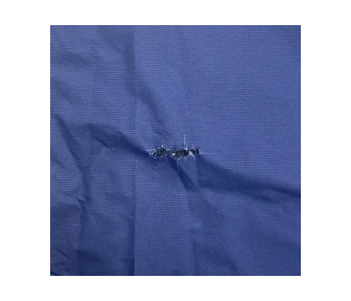 Rainwear before repair: Water was leaking through a tear.