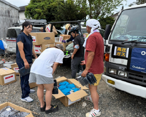 Volunteers distributing relief supplies in a disaster area.