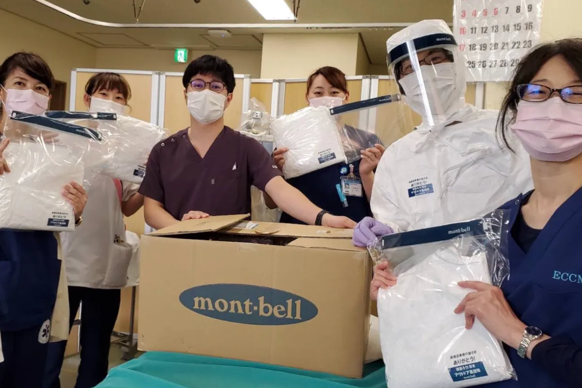 A group photo of medical workers receiving provided protective gear.