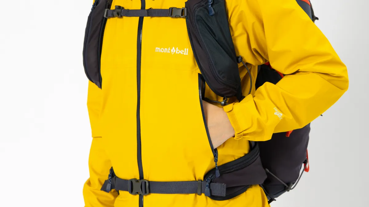 Pocket positioned to minimize interference with backpack harness and straps