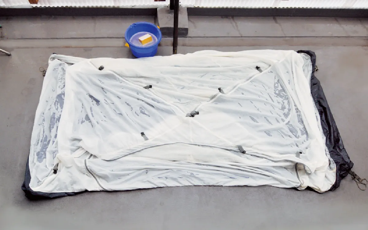 The tent is flipped over and spread out with the base part facing downwards on the ground.