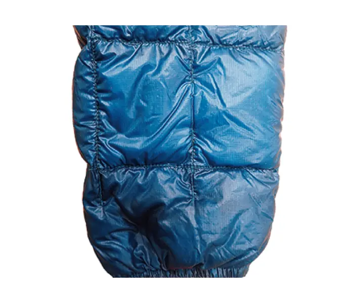 Down jacket after repair: Down refilled and patches applied along quilt seams.