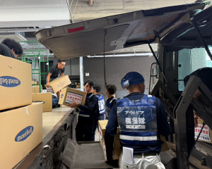 Volunteers loading relief supplies into a car.