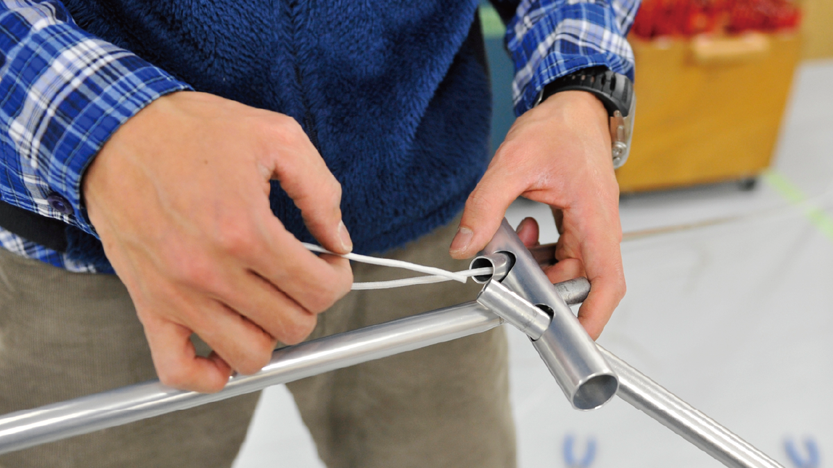 Manually replacing shock cords in tent poles.