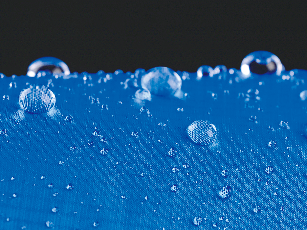 Water droplets beading on the fabric, demonstrating effective water repellency