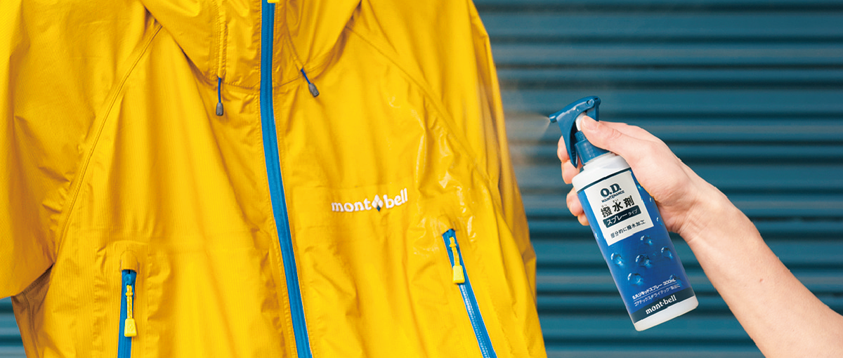 Scene of spraying water repellent on yellow rain gear