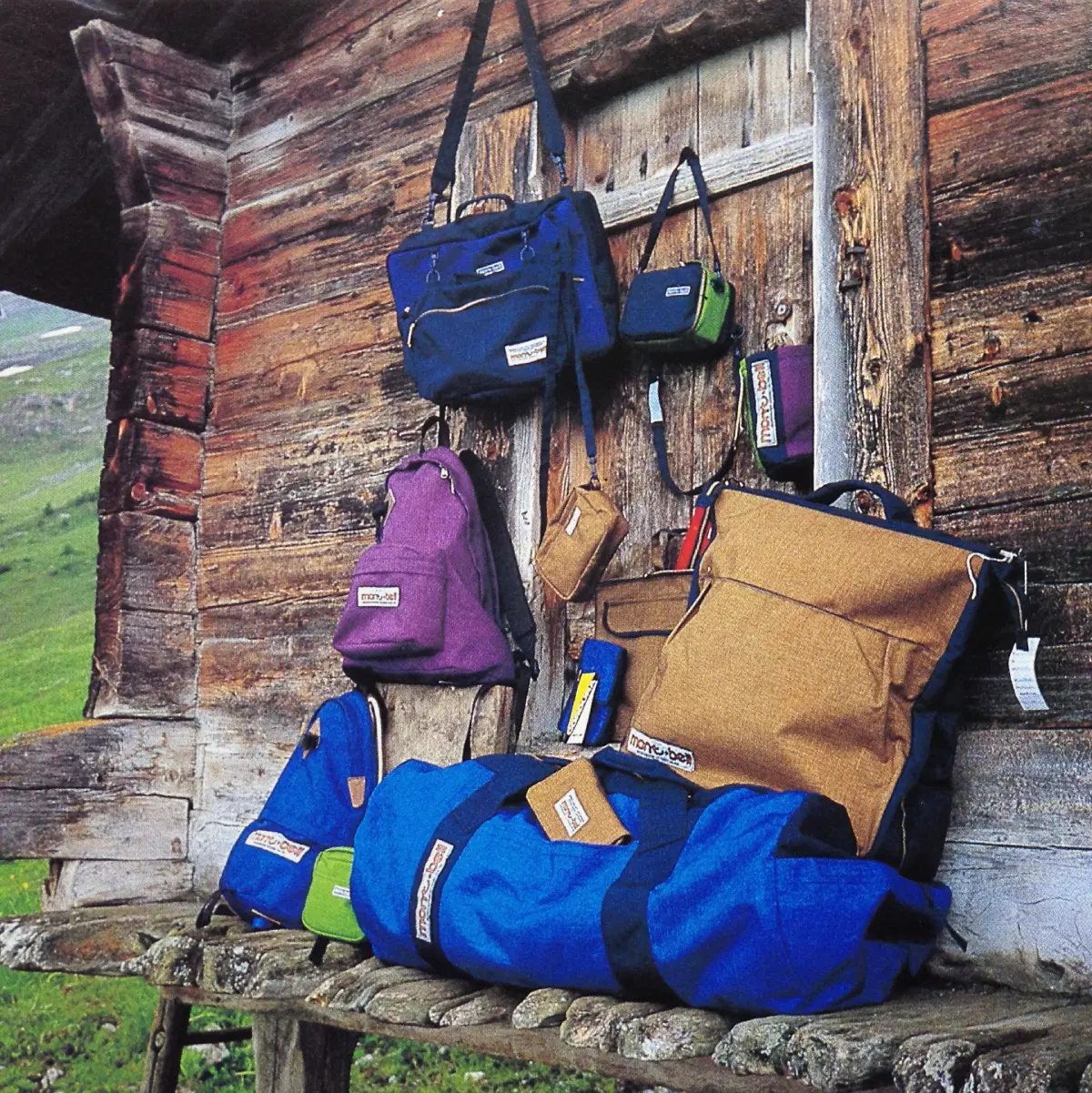 Bags and backpacks made with DuPont's Cordura nylon lined up on the wall of a wooden cabin
