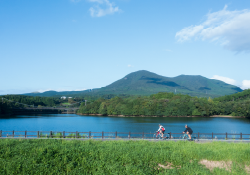 A pair of cyclists riding along Omura Bay