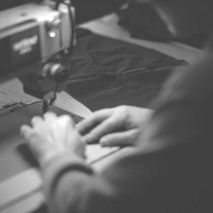 Someone performing sewing work using a sewing machine.