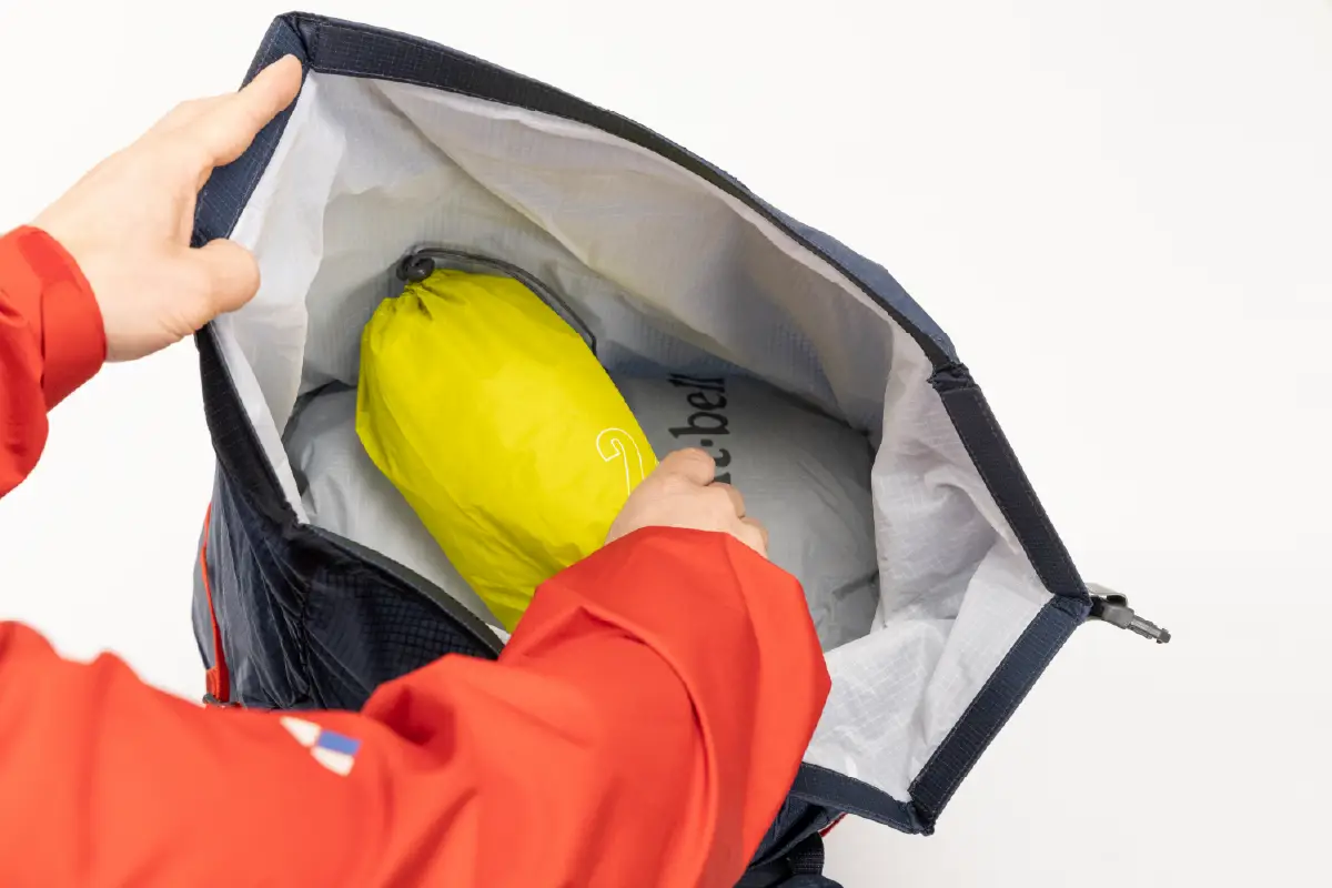 Taking a yellow stuff sack out through the opening