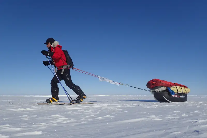 Mr. Sekiguchi pulling a sled on the ice