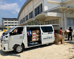 Unloading and carrying relief supplies from a vehicle.