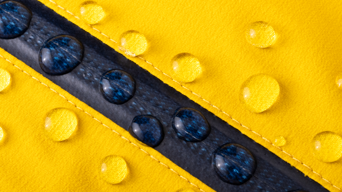Water droplets beading on a metal zipper, creating a sleek, water-resistant effect