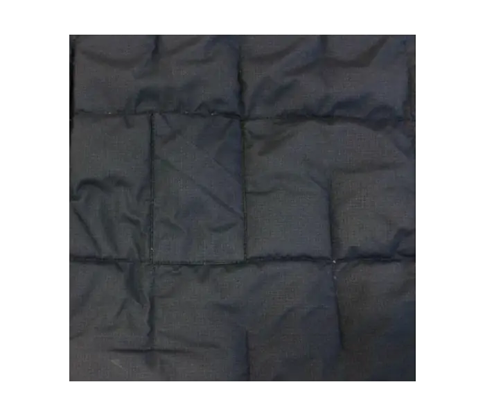 Down jacket after repair: Patches applied while preserving original seams as much as possible.